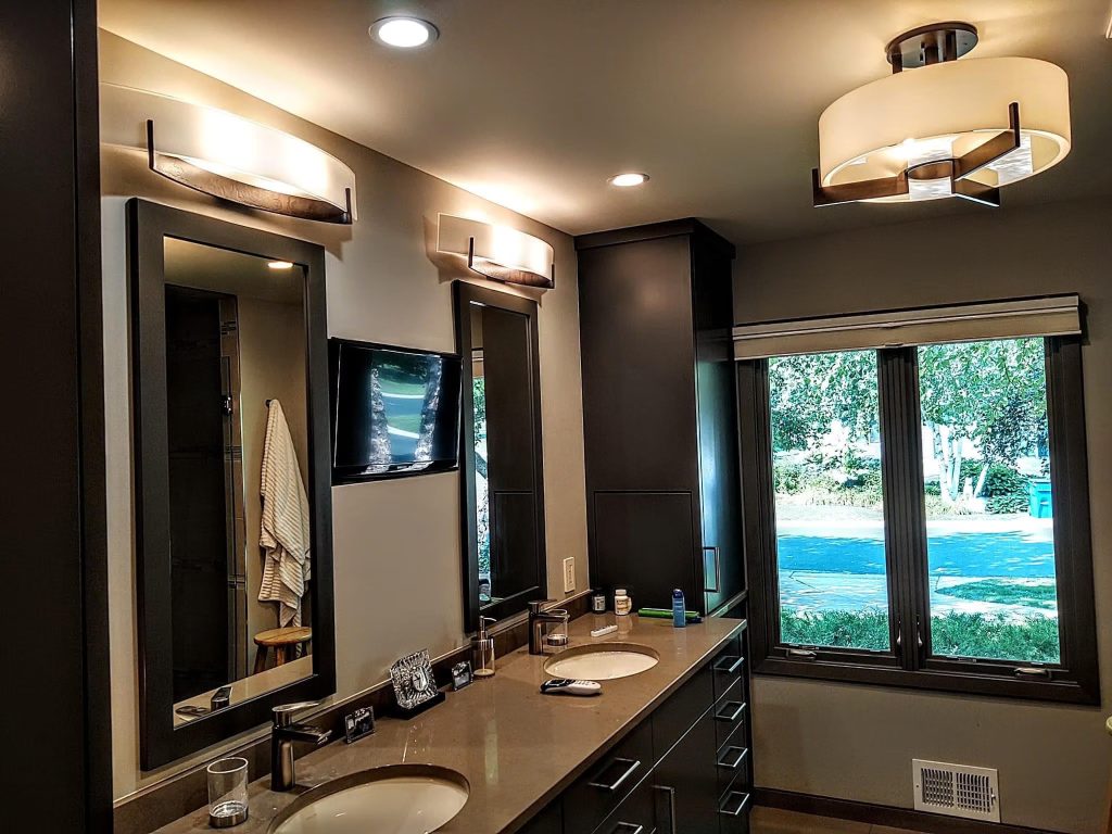Modern bathroom vanity with wall fixtures and recessed lighting