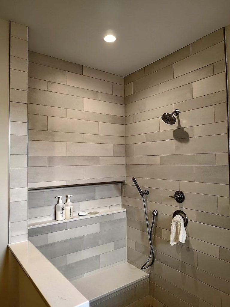 Custom tiled shower with recessed ceiling lighting